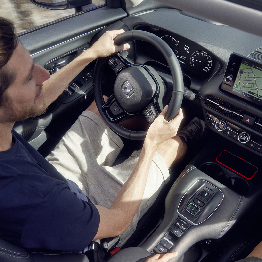 Man driving ZR-V showing satnav on dashboard