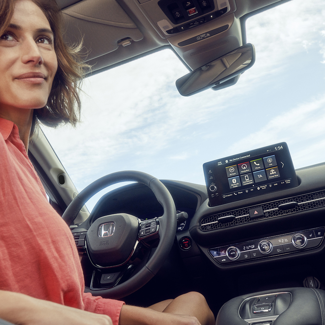 Woman in drivers seat looking back