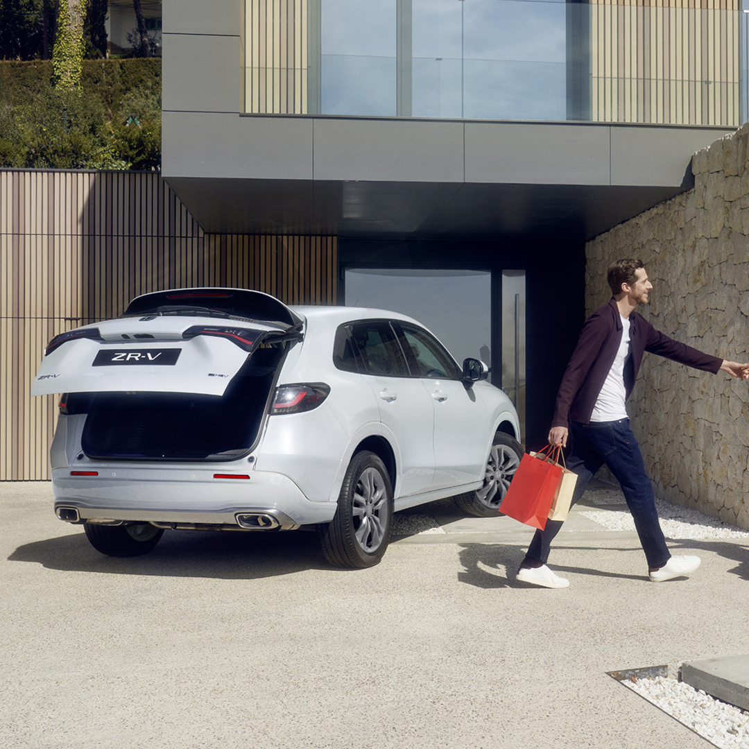 White ZR-V in driveway with power tailgate