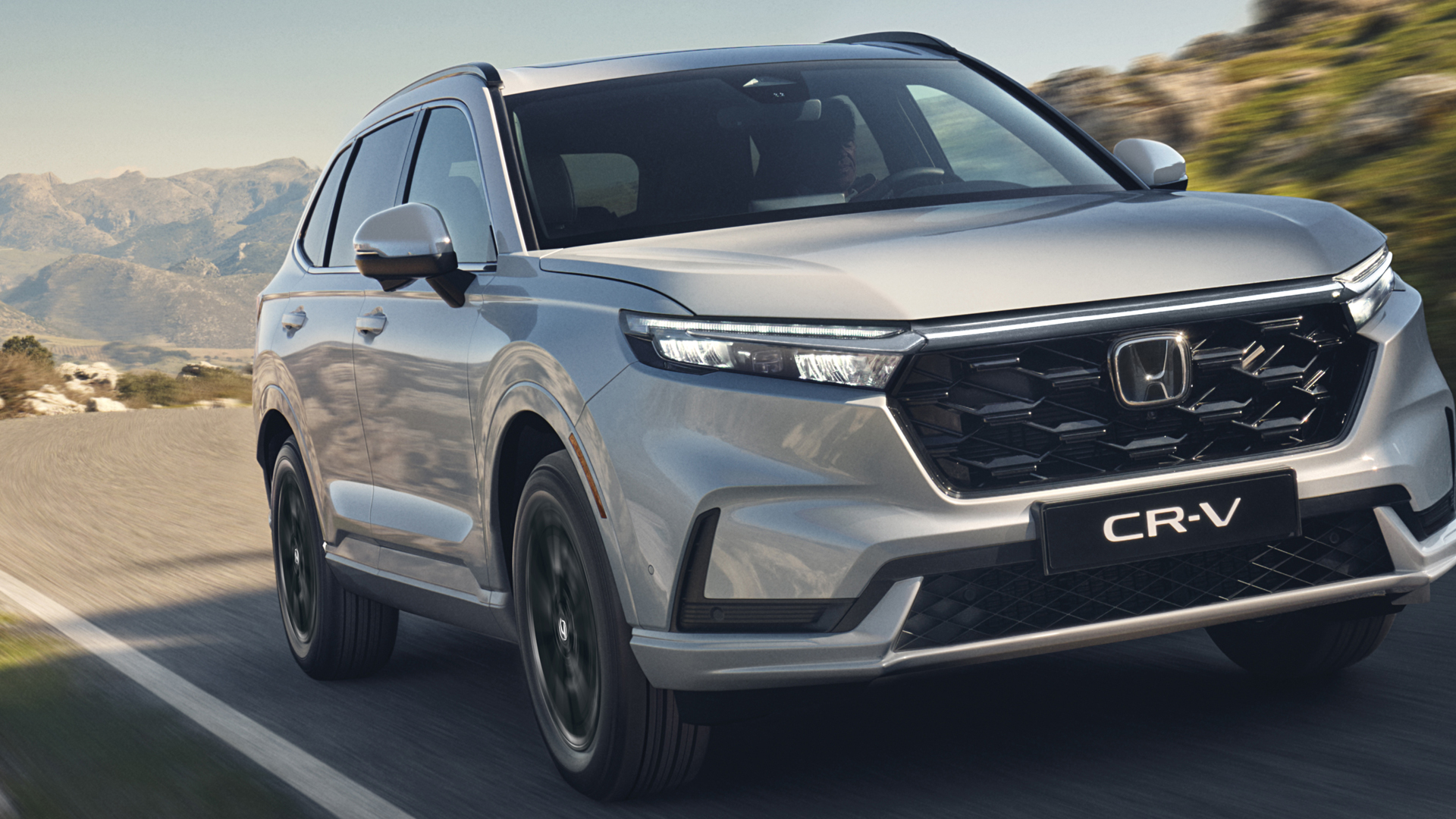 Driekwart vooraanzicht Honda CR-V Hybrid, in de bergen.