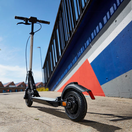 eSYMO geparkeerd tegen een fel gekleurde muur