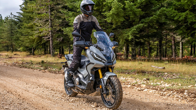 Honda X-ADV - driekwartvooraanzicht van rechts, met bestuurder, bosweg