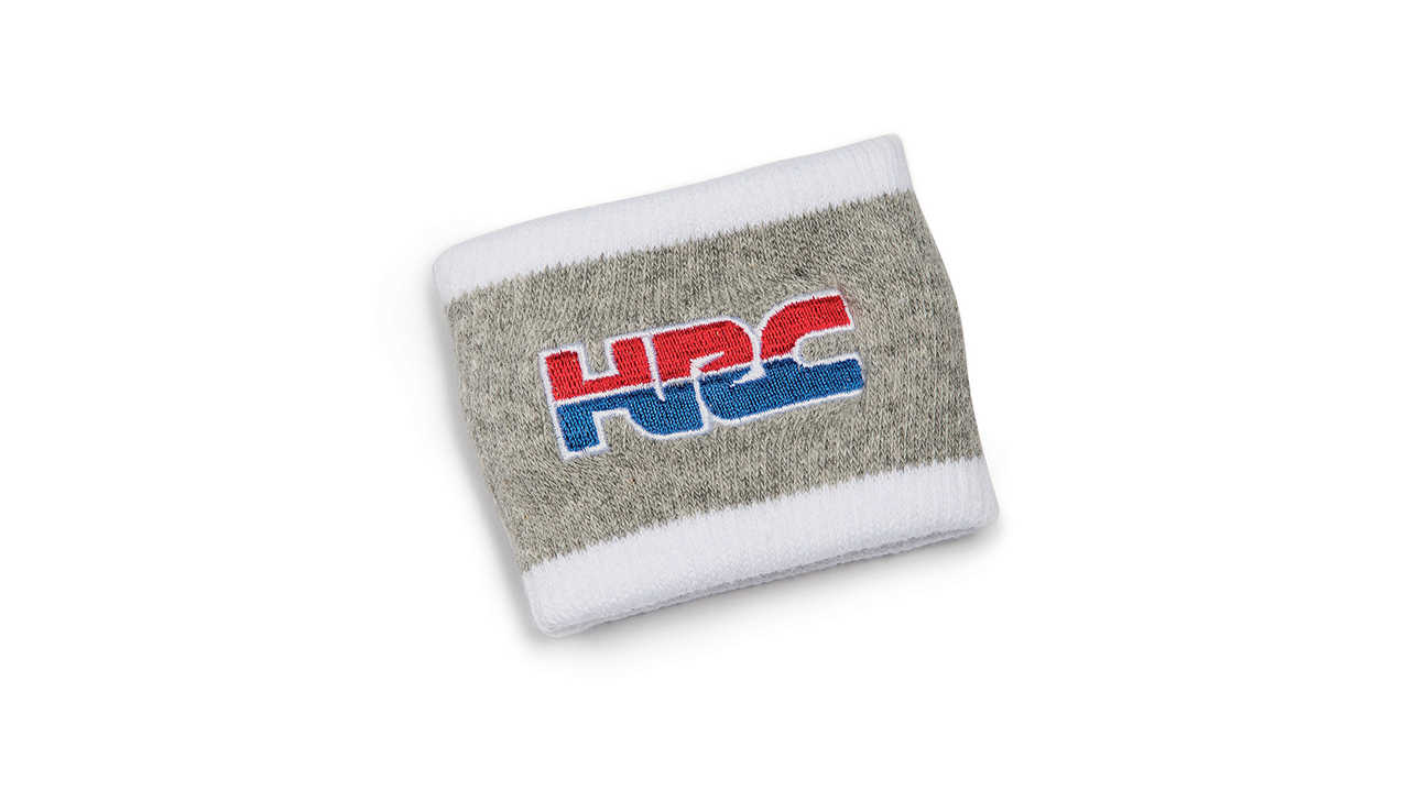 Grijze Honda HRC polsband in HRC-kleuren met logo Honda Racing Corporation.