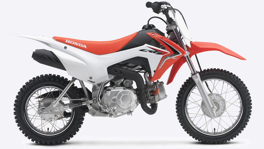 Zijaanzicht, met zicht op rechterkant van rode CRF110F.
