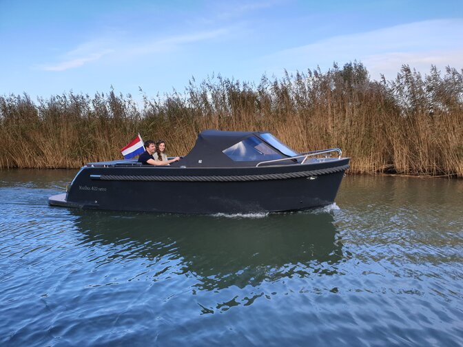 Man and lady on a Maxima boat with a Honda engine on the thames in London