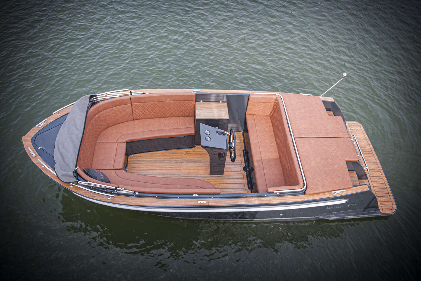 photo of man in life jacket steering maxima boat